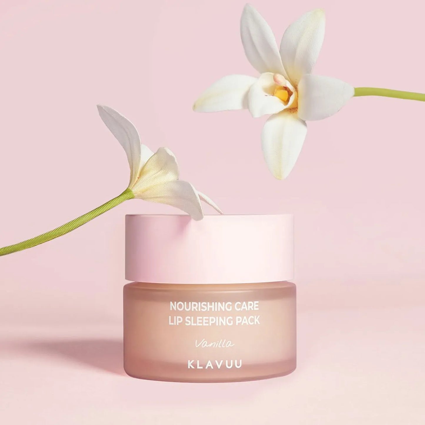 KLAVUU nourishing care lip sleeping pack with a white orchid on a pink background